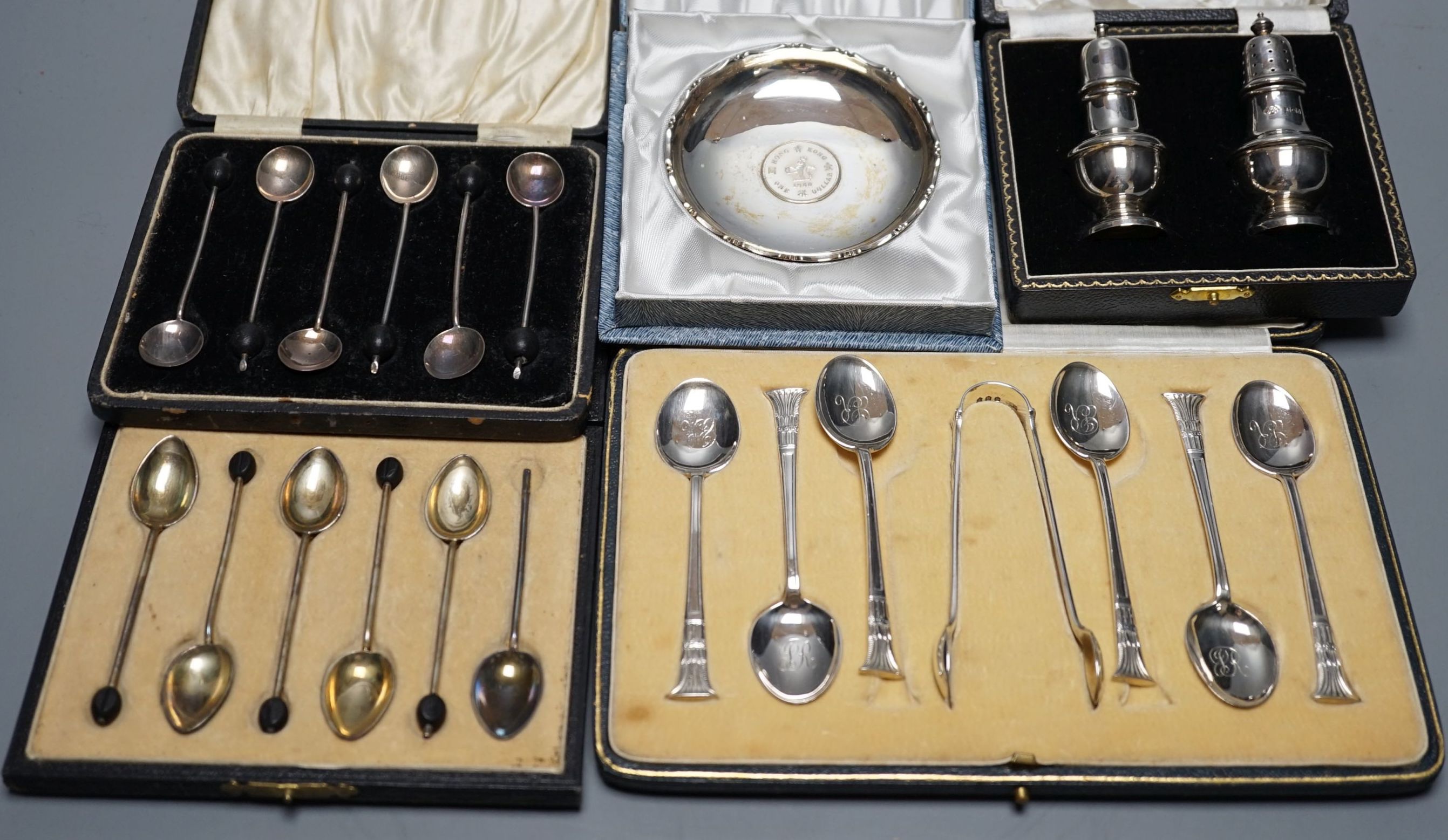 Two cased sets of six silver coffee spoons including enamel(a.f.) and bean end and three other cased sets including teaspoons with tongs, pepperettes and dish.
